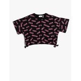 Koton 9D9 Kız Çocuk Crop Oversize Kısa Kollu Baskılı Yanları Fiyonk Detaylı Bisiklet Yaka Siyah Desenli T-shirt